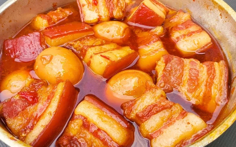 Thit kho nuoc dua – pork braised in coconut milk, where coconut water sweetens the meat and gives it an appetizing amber color
